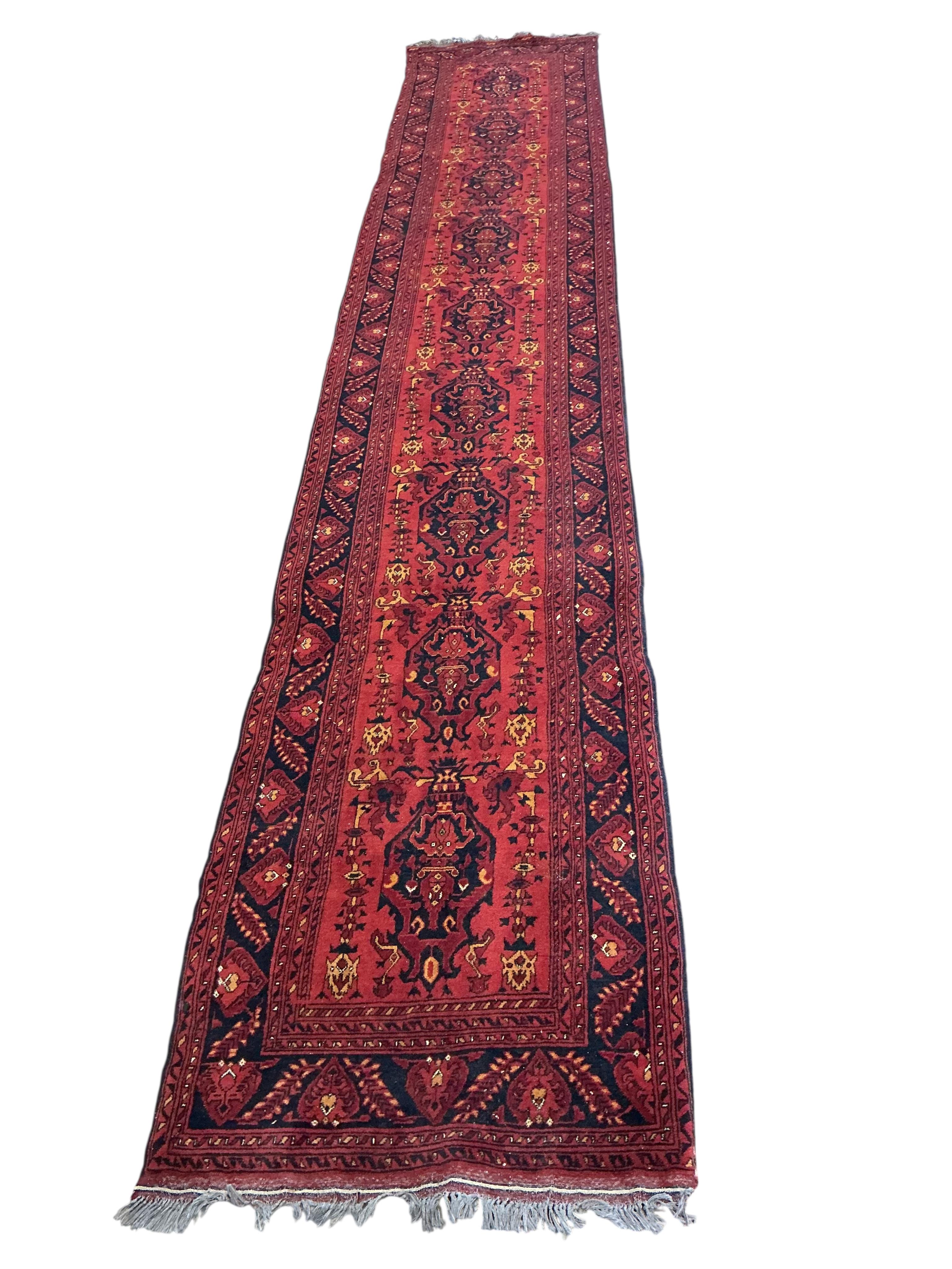 A 20th century red ground Persian runner, approx. 480 x 84cm